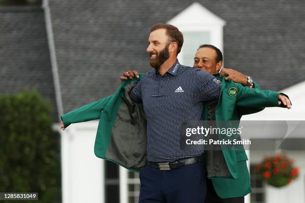 Dustin Johnson of the United States is awarded the Green Jacket by Masters champion Tiger Woods of the United States during the Green Jacket Ceremony...