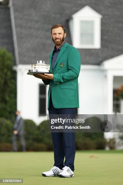 Dustin Johnson of the United States poses with the Masters Trophy during the Green Jacket Ceremony after winning the Masters at Augusta National Golf...