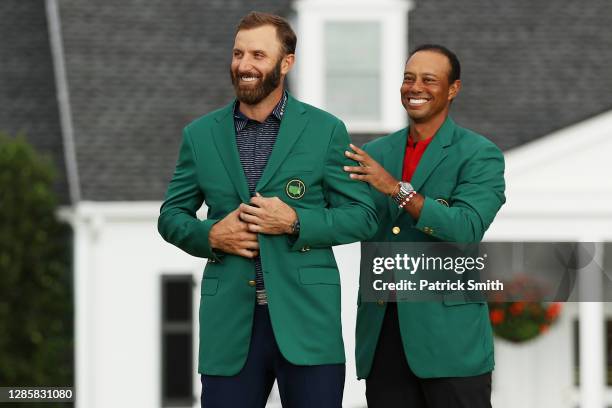 Dustin Johnson of the United States is awarded the Green Jacket by Masters champion Tiger Woods of the United States during the Green Jacket Ceremony...