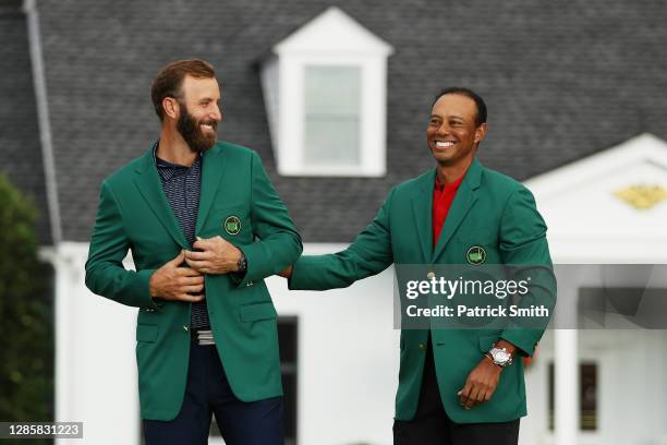 Dustin Johnson of the United States is awarded the Green Jacket by Masters champion Tiger Woods of the United States during the Green Jacket Ceremony...