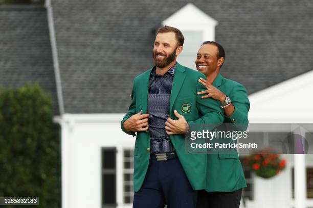 Dustin Johnson of the United States is awarded the Green Jacket by Masters champion Tiger Woods of the United States during the Green Jacket Ceremony...