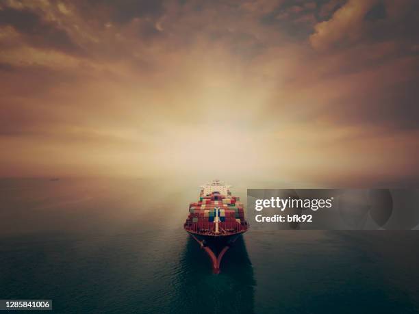 aerial view of cargo ship in transit. - container stock pictures, royalty-free photos & images
