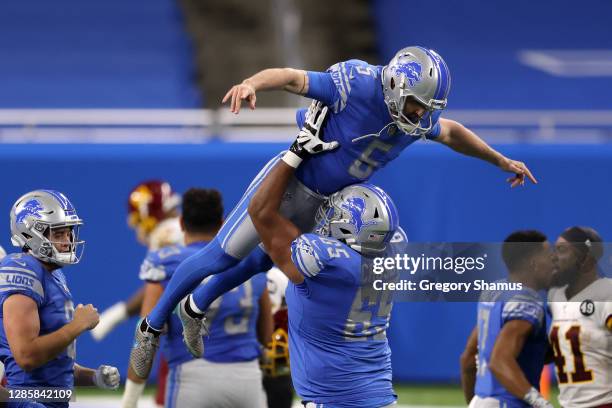 Matt Prater of the Detroit Lions celebrates with his team after kicking the game-winning field goal during their game against the Washington Football...