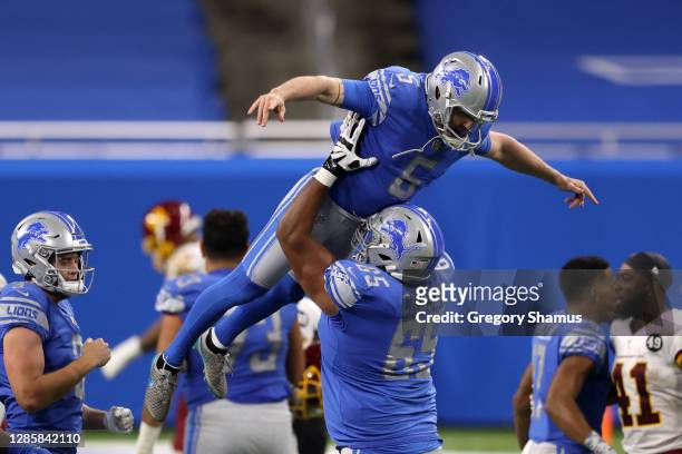 Matt Prater of the Detroit Lions celebrates with his team after kicking the game-winning field goal during their game against the Washington Football...