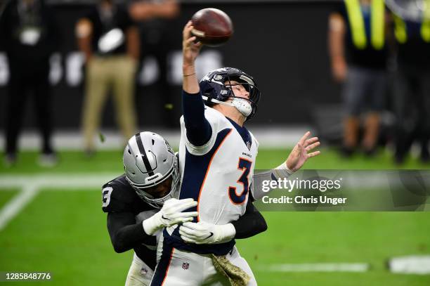 Defensive tackle Johnathan Hankins of the Las Vegas Raiders hits quarterback Drew Lock of the Denver Broncos in the first half of their game at...