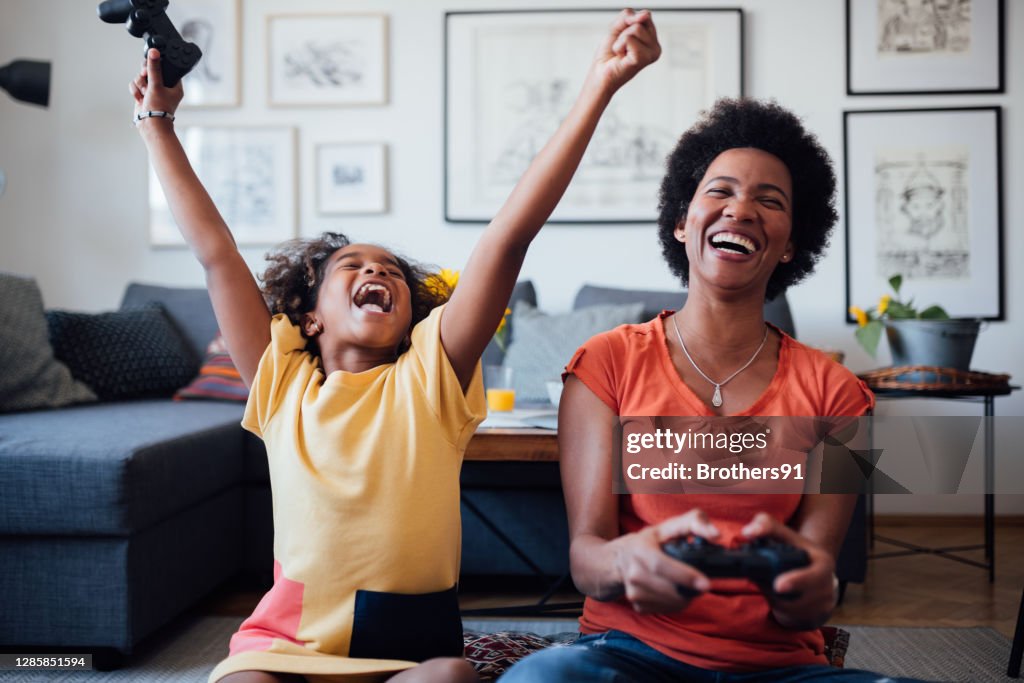 African American mother and daughter having fun at home