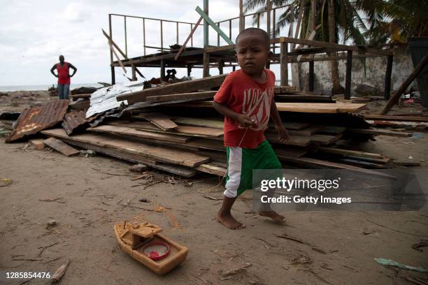 Boy plays with with a ship in the rubble of his destroyed house by hurricane ETA last month before the arrival of hurricane Iota on November 15, 2020...