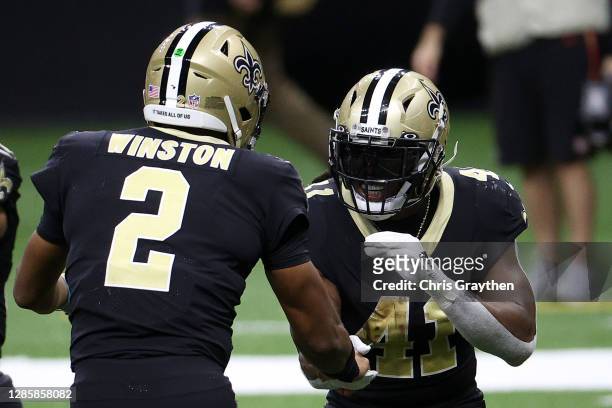 Alvin Kamara and Jameis Winston of the New Orleans Saints celebrate following a touchdown during their game against the San Francisco 49ers at...