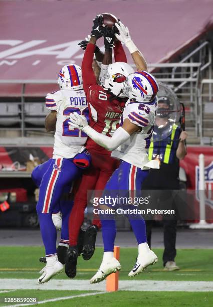 Wide receiver DeAndre Hopkins of the Arizona Cardinals catches the game-winning touchdown pass as safety Jordan Poyer and safety Micah Hyde of the...