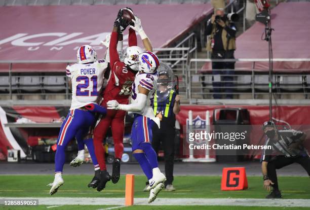 Wide receiver DeAndre Hopkins of the Arizona Cardinals catches the game-winning touchdown pass as safety Jordan Poyer and safety Micah Hyde of the...