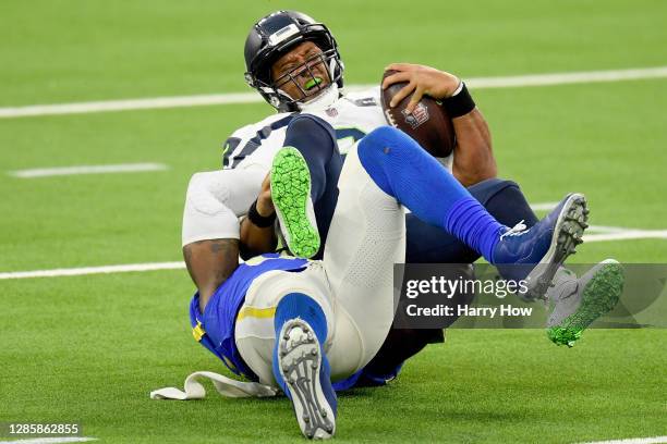 Quarterback Russell Wilson of the Seattle Seahawks is sacked by Michael Brockers of the Los Angeles Rams in the fourth quarter at SoFi Stadium on...