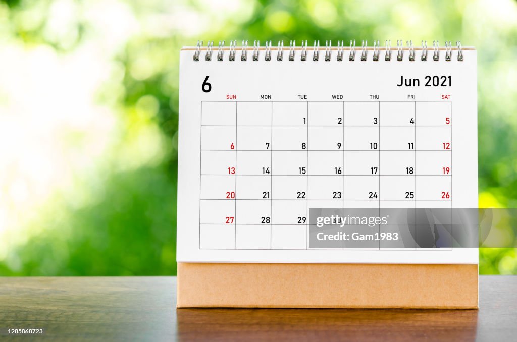 June 2021 Calendar desk for organizer to plan and reminder on wooden table