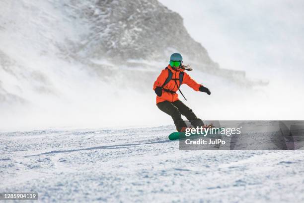 winter holidays in ski resort - women snowboarding stock pictures, royalty-free photos & images