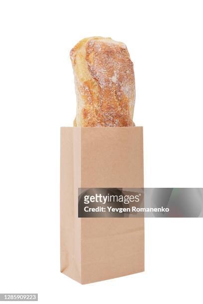 baguette in paper bag isolated on white background - paper bag stock-fotos und bilder
