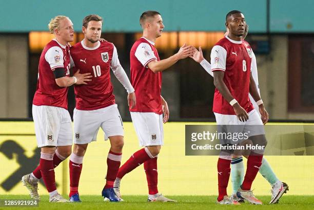 Xaver Schlager, Reinhold Ranftl, David Alaba and Louis Schaub of Austria celebrate victory after the UEFA Nations League group stage match between...