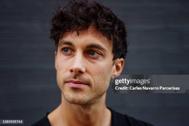 portrait of a young entrepreneur looking aside with tired face in front of an urban gray brick wall - univisions 29th edition of premio lo nuestro a la musica latina backstage stockfoto's en -beelden