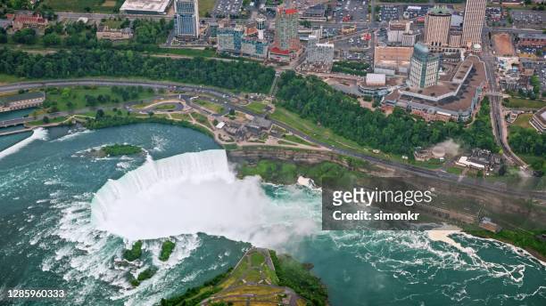view of niagara falls with cityscape - horseshoe falls niagara falls stock pictures, royalty-free photos & images