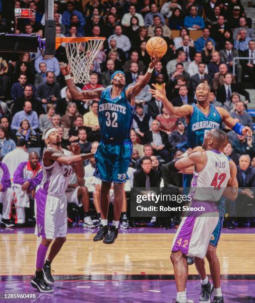 Eddie Robinson, Small Forward for the Charlotte Hornets and team mate Elden Campbell challenge for the ball over Kevin Willis and Morris Peterson of...