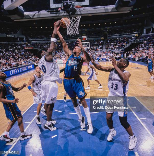 Jerome Williams, Power Forward for the Detroit Pistons and Rasheed Wallace, Center for the Washington Wizards challenge for the ball during their NBA...