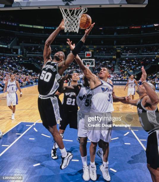 David Robinson, Center for the San Antonio Spurs and Gerard King, Small Forward for the Washington Wizards challenge for the ball during their NBA...