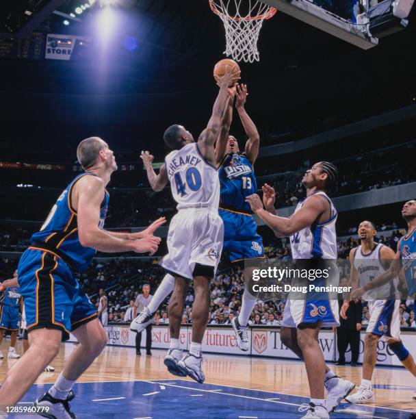 Jerome Williams, Power Forward for the Detroit Pistons and Calbert Cheaney, Shooting Guard for the Washington Wizards challenge for the ball during...
