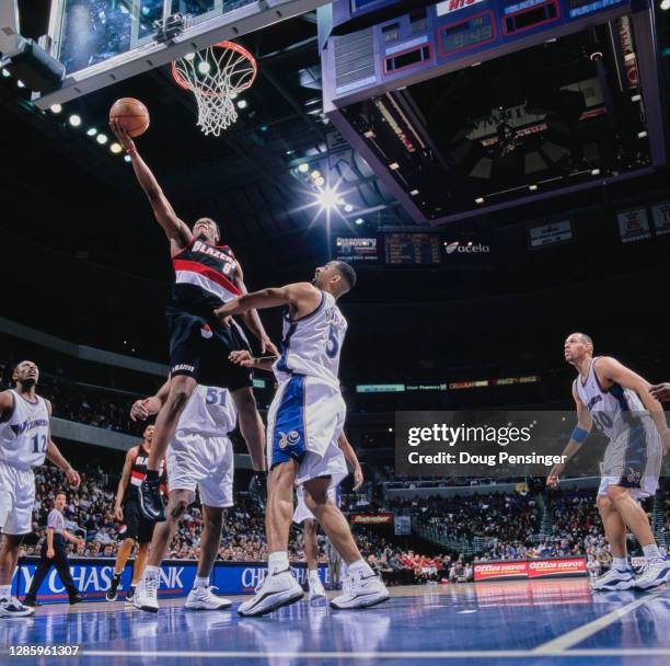 Bonzi Wells, Shooting Guard for the Portland Trail Blazers makes a one handed lay up over Juwan Howard of the Washington Wizards during their NBA...
