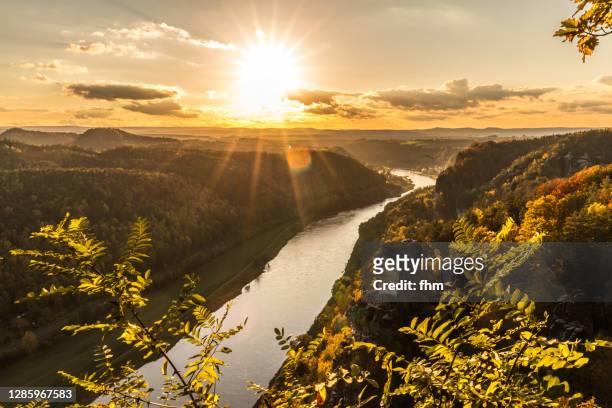 sunset at elbe river in the elbe sandstone mountains (german: elbsandsteingebirge), saxony/ germany - saxony stock pictures, royalty-free photos & images
