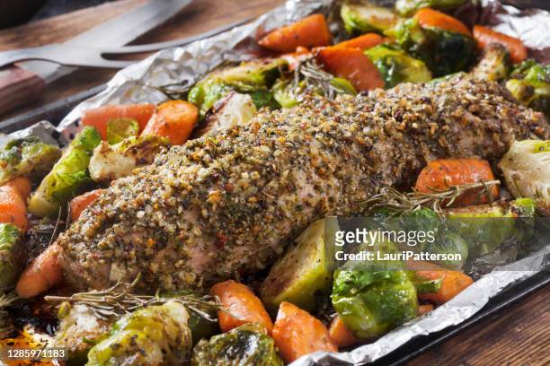 garlic and herb crusted pork tenderloin with roasted brussels sprouts and carrots - baking tray stock pictures, royalty-free photos & images