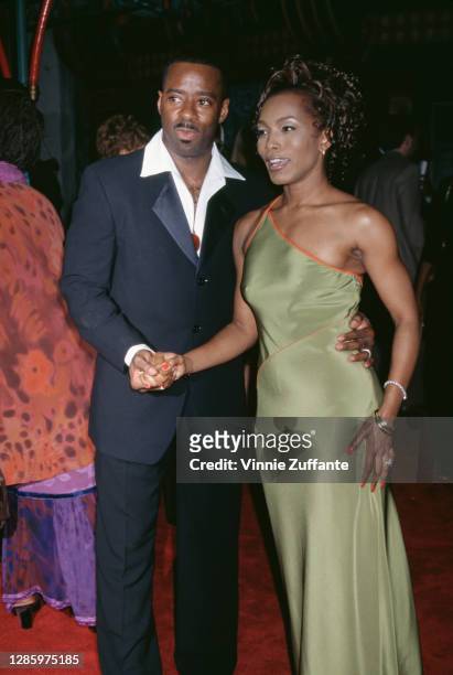 American actor Courtney B Vance and his wife, American actress Angela Bassett, wearing a green asymmetric evening gown, attend the premiere of 'How...