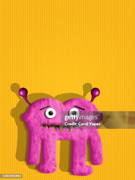 pink sweet monster in yellow background - monster fictional character stock pictures, royalty-free photos & images