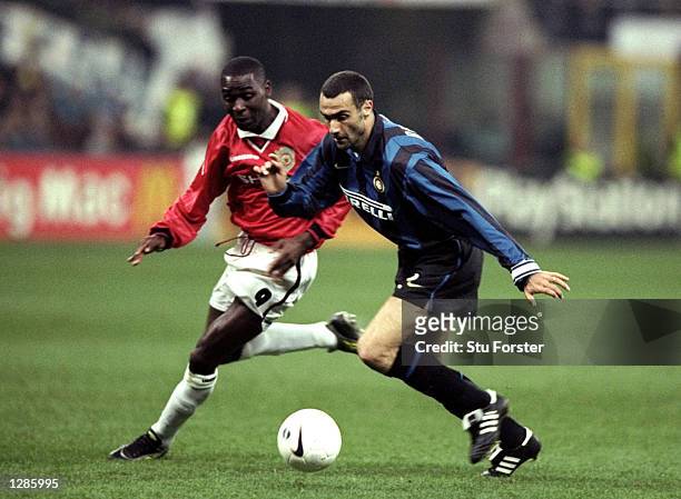 Giuseppe Bergomi of Inter Milan is chased by Andy Cole of Manchester United in the UEFA Champions League quarter-final second leg match at the San...