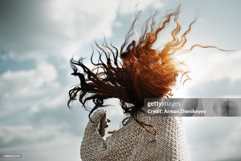 Redhead woman with wind blown hair