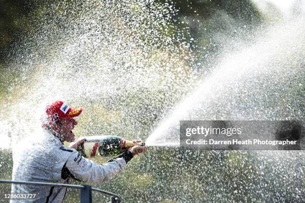 Brazilian Brawn Formula One driver Rubens Barrichello on the winners podium sprays champagne in celebration of winning the 2009 Italian Grand Prix at...