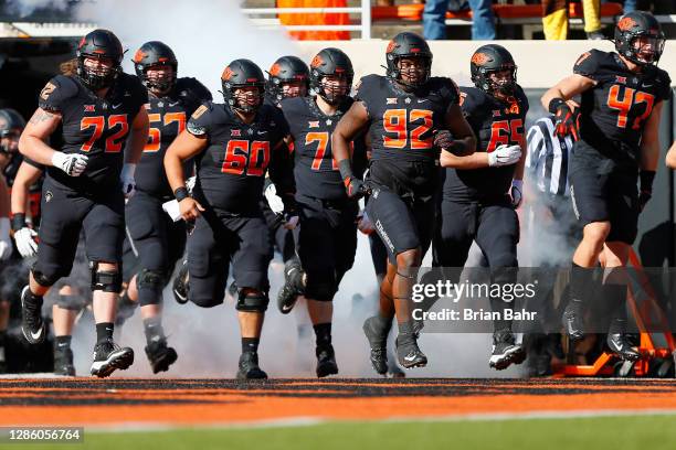 Offensive lineman Josh Sills, offensive lineman Tyrese Williams, defensive tackle Cameron Murray, and linebacker Carson Kropp of the Oklahoma State...