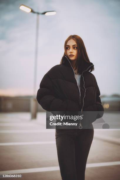 teenage woman on parking garage rooftop looking over - girl of desire stock pictures, royalty-free photos & images