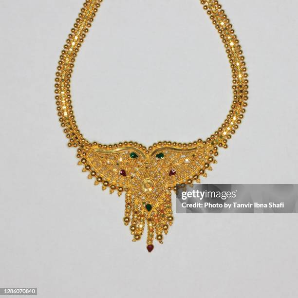 beautiful indian style gold necklace/jewelry laying on white background - choker necklace stock pictures, royalty-free photos & images