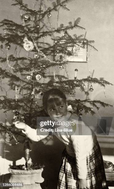 child playing with christmas tree. 1955. - christmas tree 50's stock pictures, royalty-free photos & images