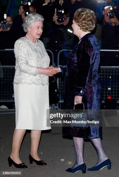 Queen Elizabeth II is greeted by former Prime Minister Baroness Margaret Thatcher as they attend Margaret Thatcher's 80th birthday party at the...