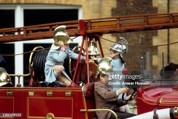 Prince William , Prince Harry and Peter Phillips play on a fire engine at Sandringham on January 3, 1988 in Sandringham, England.