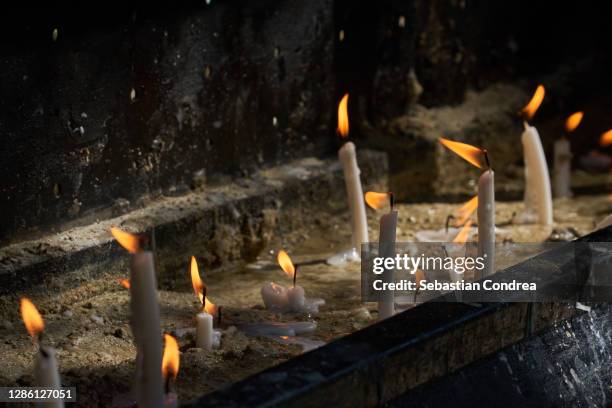 candles burning at a place of worship, horizontal. - candle death stock pictures, royalty-free photos & images