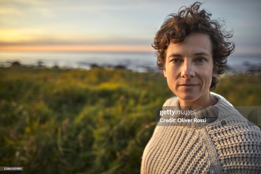 Portrait of brunette woman at the coast.