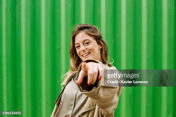 happy young woman pointing her finger - 人差し指 女性 ストックフォトと画像