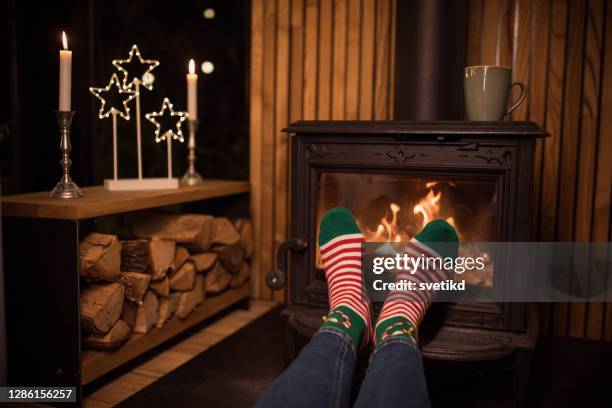 winter day by fireplace - cosy socks stock pictures, royalty-free photos & images