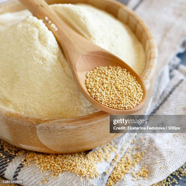 close-up of rice in wooden spoon on table - amarant stock pictures, royalty-free photos & images