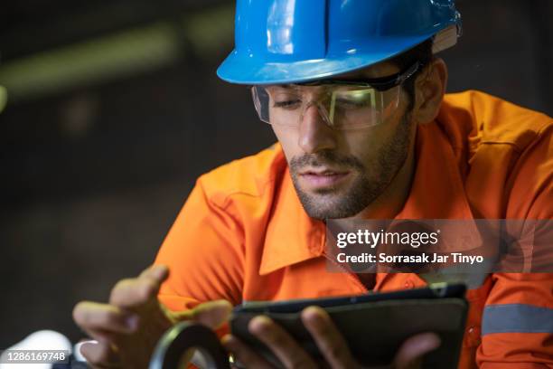 engineer using tablet in petrochemical industry. - petrokemisk fabrik bildbanksfoton och bilder