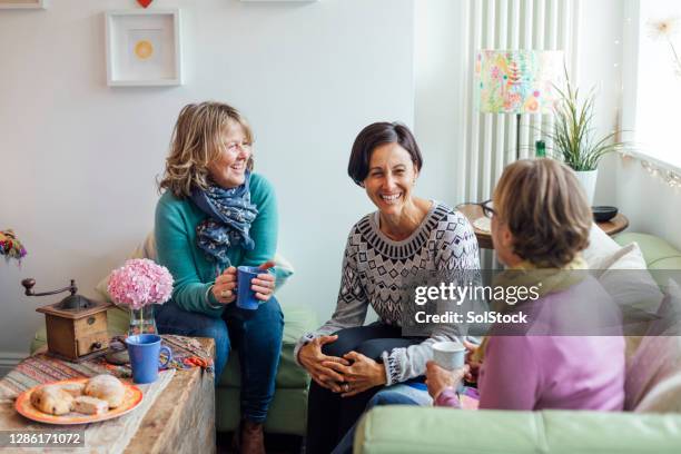 friends laughing together - only mature women stock pictures, royalty-free photos & images