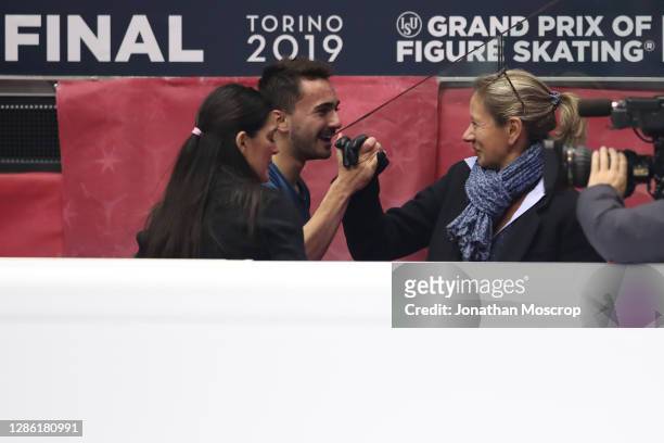Kevin Aymoz of France pictured with his Italian coach Silvia Fontana and Katia Krier following his performance in the Men's Free Skating during the...