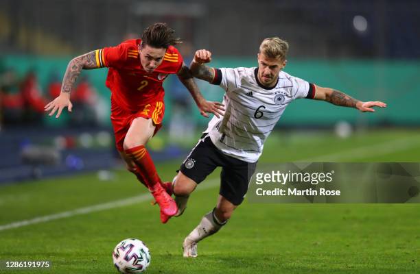 Cameron Coxe of Wales is challenged by Niklas Dorsch of Germany during the UEFA Euro Under 21 Qualifier match between Germany U21 and Wales U21 at...