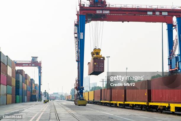 crane lifting container and loading the freight train. - tank car stock pictures, royalty-free photos & images