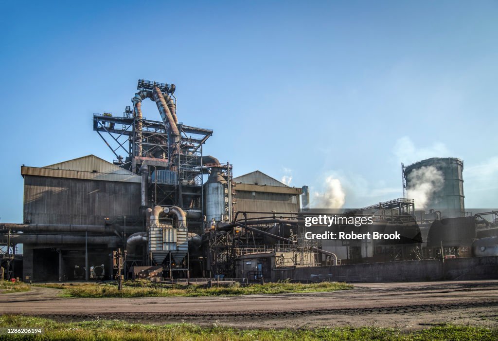 Primary steel mill with blast furnace in view.